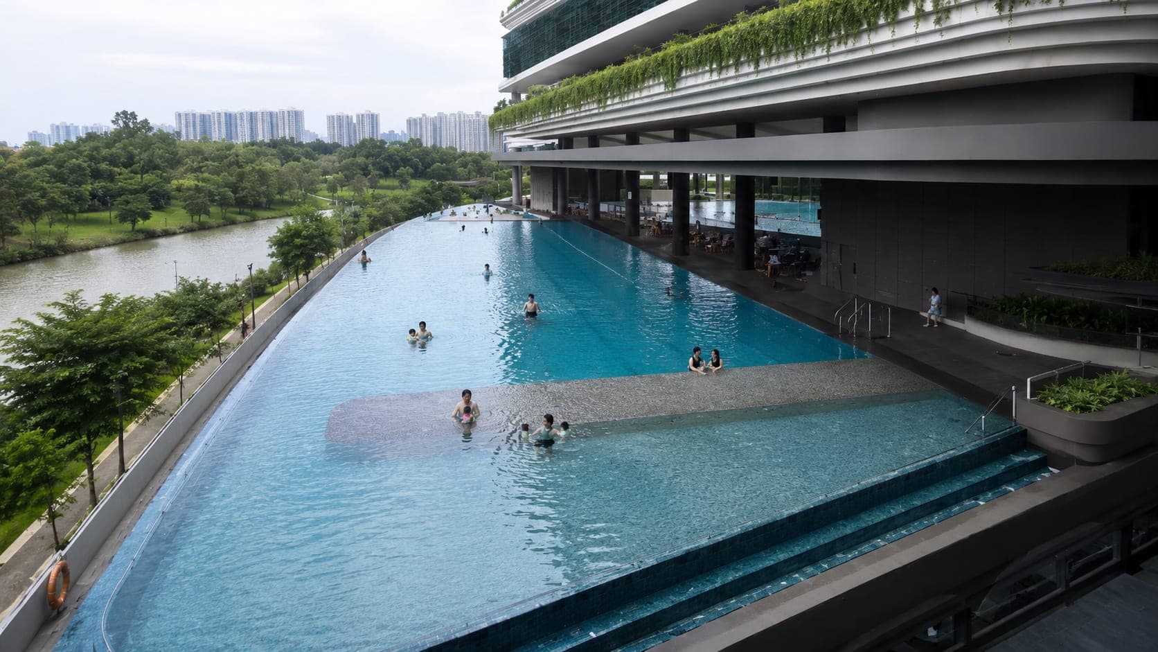 Aerial view of a condominium infinity pool overlooking Punggol Waterway